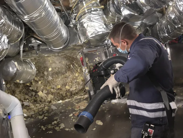 Valley Falls Air Duct Cleaning specialist operating negative pressure cleaning equipment for thorough duct maintenance in Valley Falls