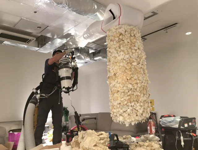 Valley Falls Air Duct Cleaning technician performing precision vacuum insulation removal in a residential property in Valley Falls